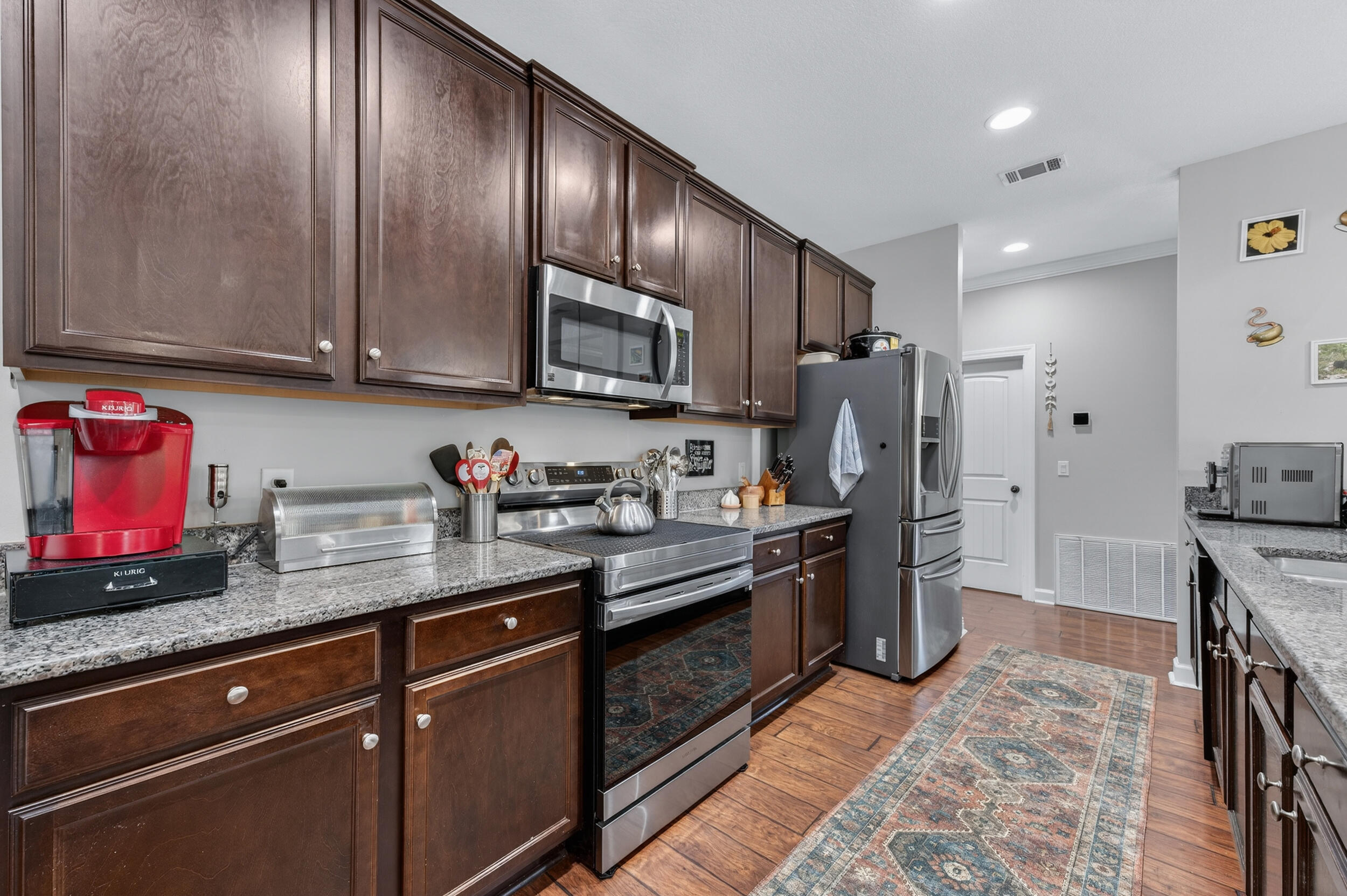 6022 Hidden Valley Road Crestview, FL 32539 - Photo 24 of 60 a kitchen with stainless steel appliances granite countertop a refrigerator stove and sink