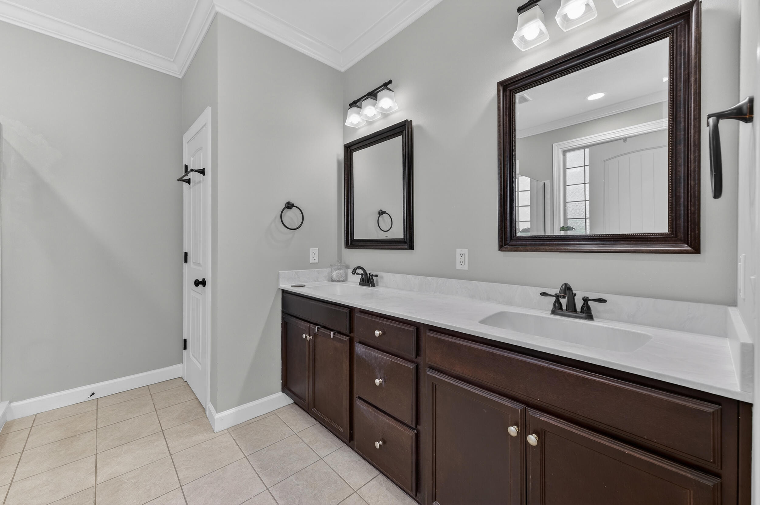 6022 Hidden Valley Road Crestview, FL 32539 - Photo 36 of 60 a bathroom with a double vanity sink and mirror