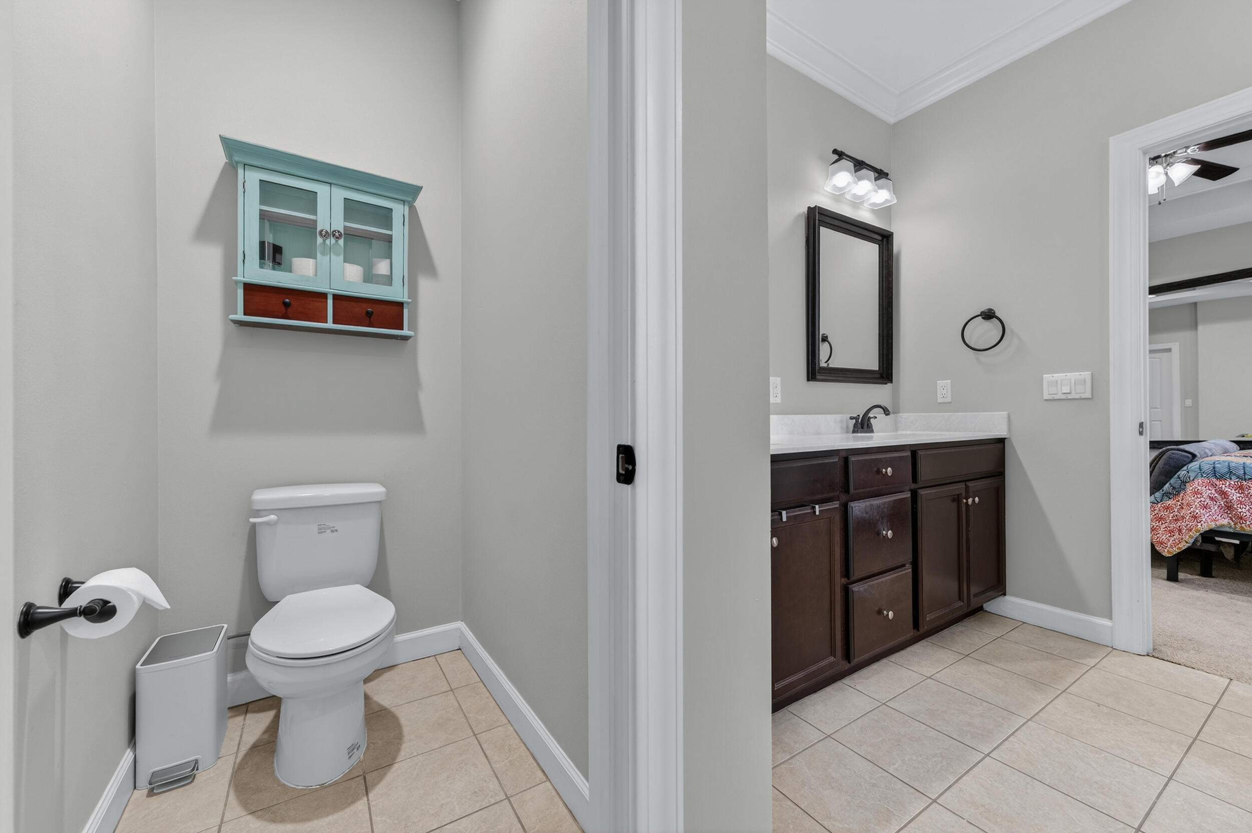 6022 Hidden Valley Road Crestview, FL 32539 - Photo 40 of 60 a bathroom with a toilet sink and mirror