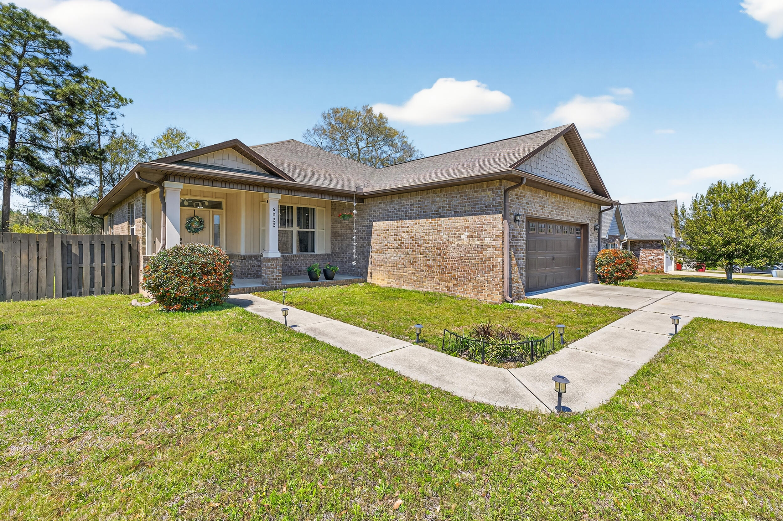 6022 Hidden Valley Road Crestview, FL 32539 - Photo 4 of 60 a front view of a house with garden