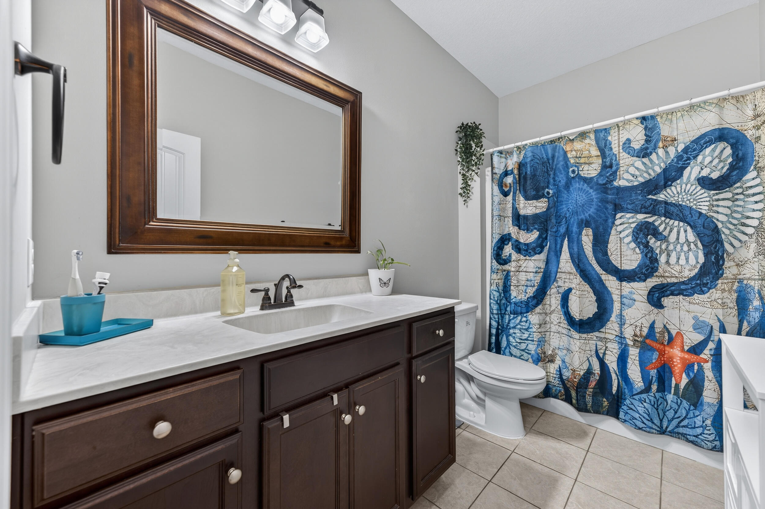 6022 Hidden Valley Road Crestview, FL 32539 - Photo 44 of 60 a bathroom with a granite countertop toilet sink and mirror