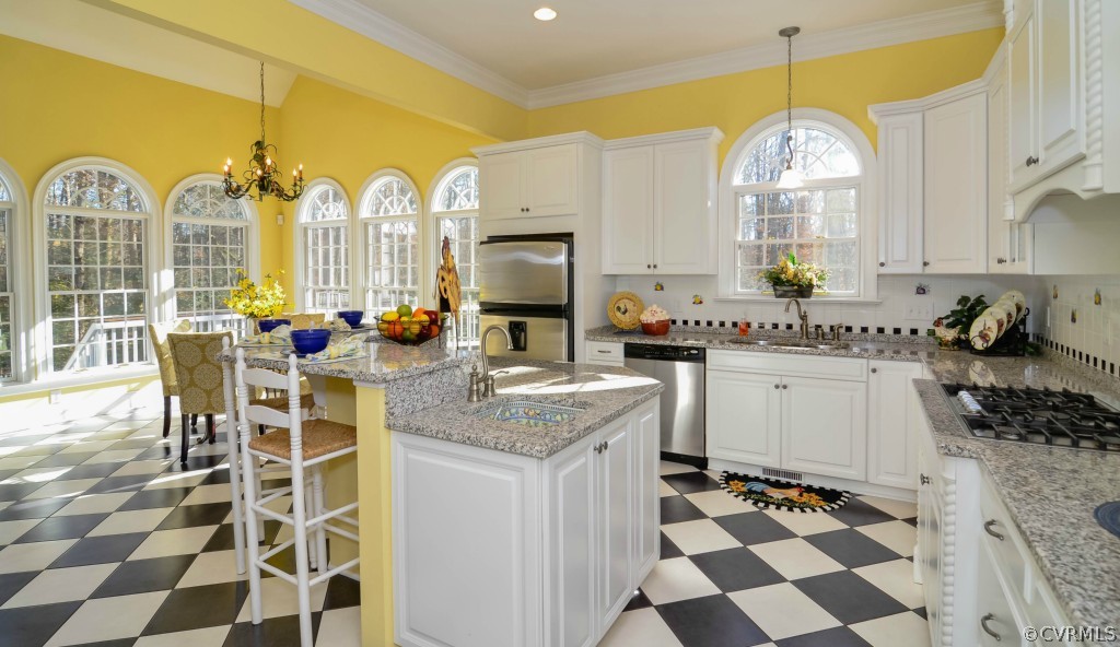 1933 Covington Road Crozier, VA 23039 - Photo 3 of 24 a kitchen with a chandelier a sink and cabinets