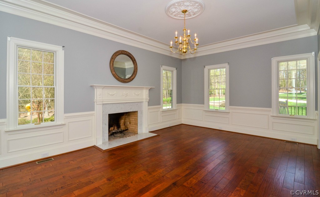 1933 Covington Road Crozier, VA 23039 - Photo 6 of 24 a view of an empty room with wooden floor fireplace and a window