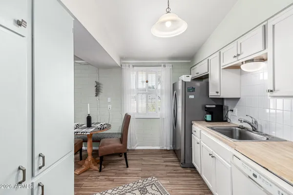 a view of a kitchen area with furniture and wooden floor