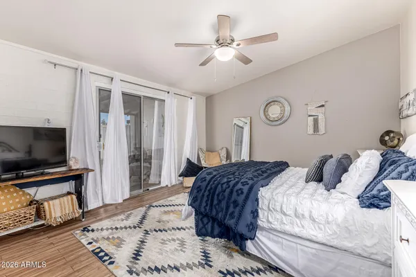 a bedroom with a large bed and a flat screen tv