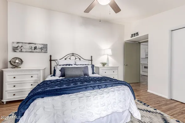 a bedroom with a large bed and a dresser