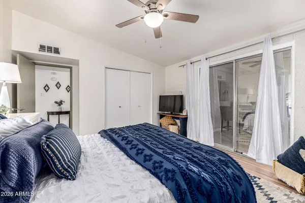 a bedroom with a bed and a flat tv screen