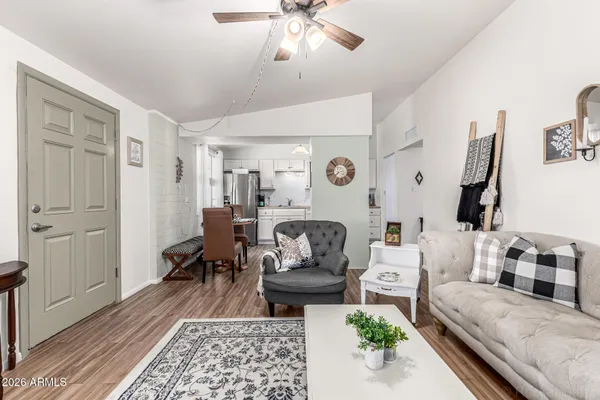 a living room with furniture and wooden floor