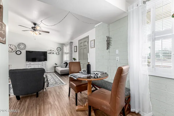a living room with furniture a flat screen tv and a window