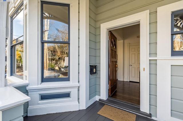 a view of entryway with wooden floor and stairs