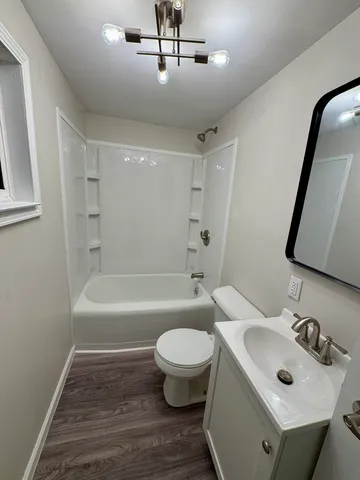 a bathroom with a sink toilet tub and shower