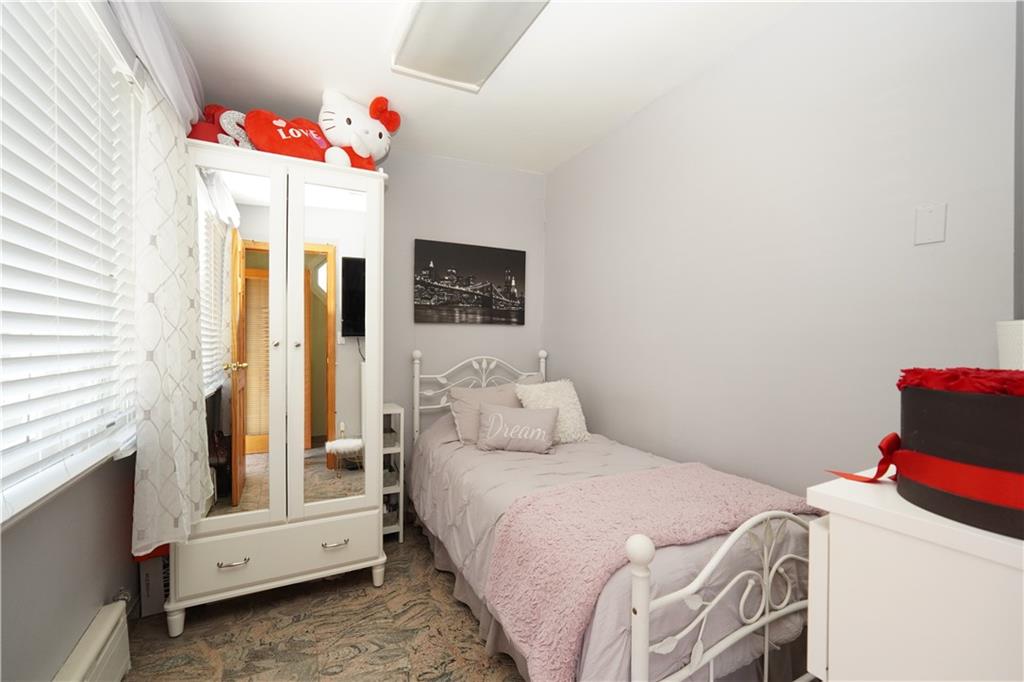 1463 84th Street Brooklyn, NY 11228 - Photo 11 of 30 a bedroom with a bed and a window