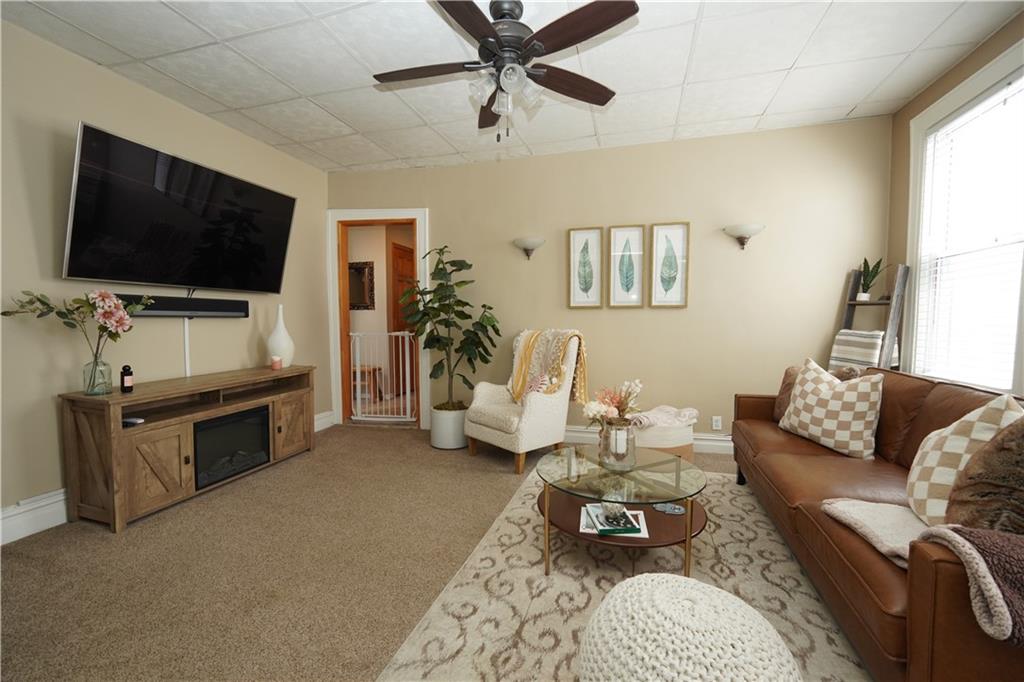 1463 84th Street Brooklyn, NY 11228 - Photo 16 of 30 a living room with furniture and a flat screen tv
