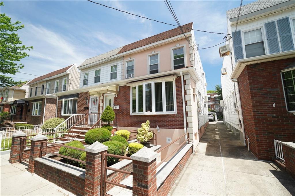 1463 84th Street Brooklyn, NY 11228 - Photo 2 of 30 a front view of a residential apartment building with a yard