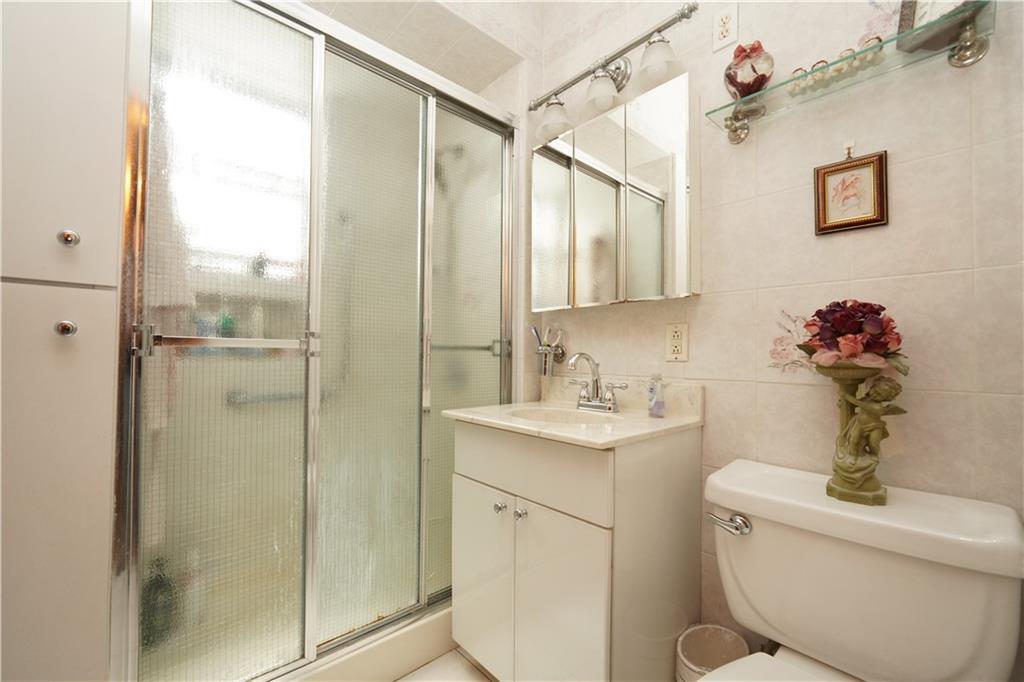 1463 84th Street Brooklyn, NY 11228 - Photo 21 of 30 a bathroom with a granite countertop sink toilet and shower