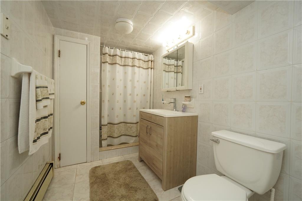 1463 84th Street Brooklyn, NY 11228 - Photo 23 of 30 a bathroom with a sink toilet and shower