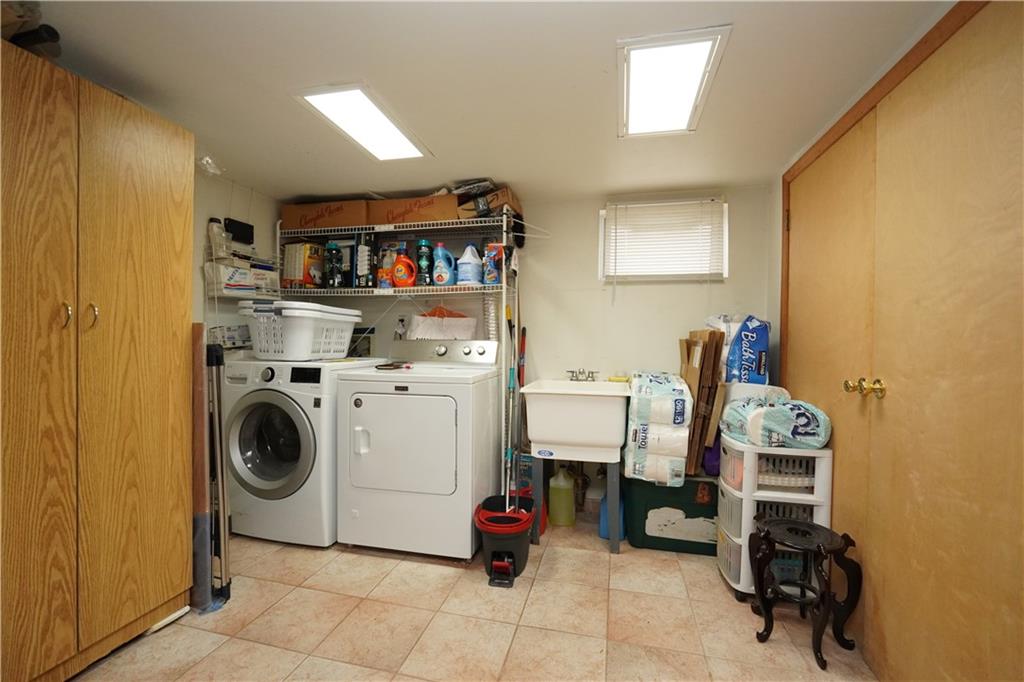 1463 84th Street Brooklyn, NY 11228 - Photo 24 of 30 a utility room with dryer washer and a view of living room
