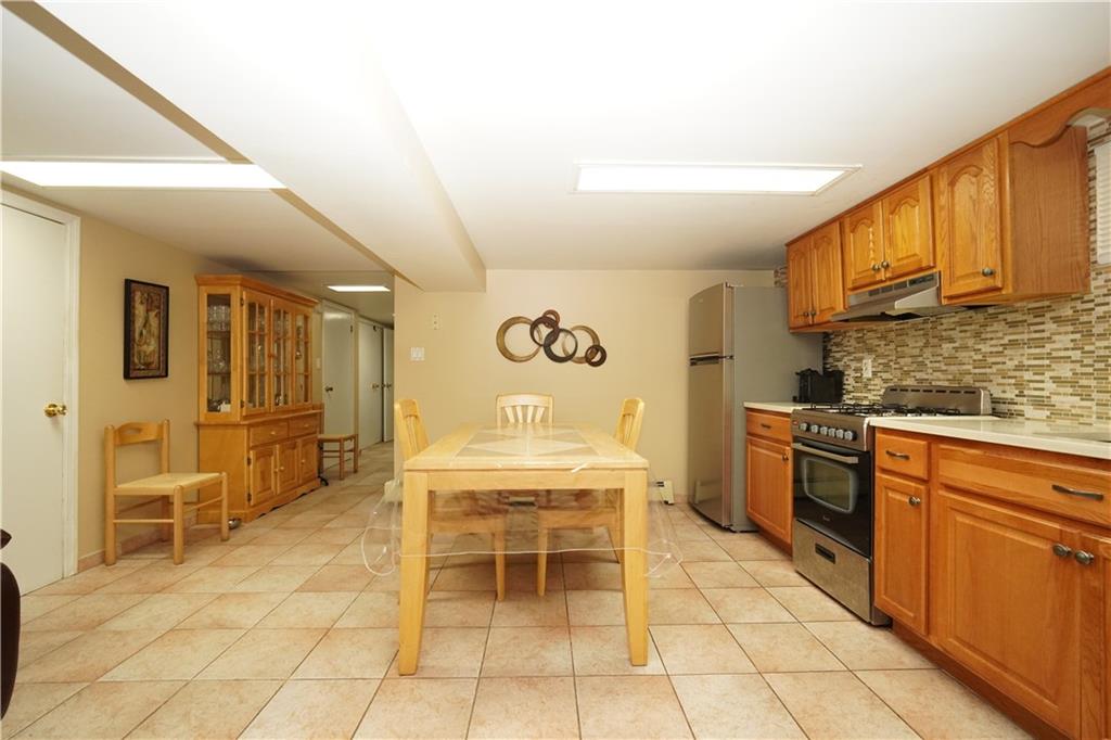 1463 84th Street Brooklyn, NY 11228 - Photo 25 of 30 a kitchen with cabinets and chairs