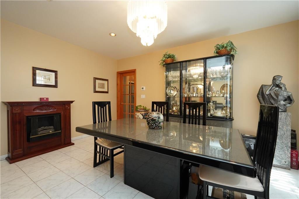 1463 84th Street Brooklyn, NY 11228 - Photo 5 of 30 a dining room with fireplace furniture and a potted plant