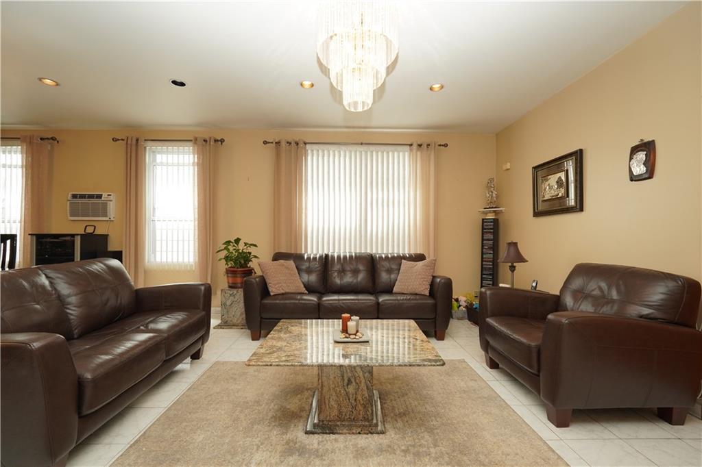 1463 84th Street Brooklyn, NY 11228 - Photo 7 of 30 a living room with furniture and a large window