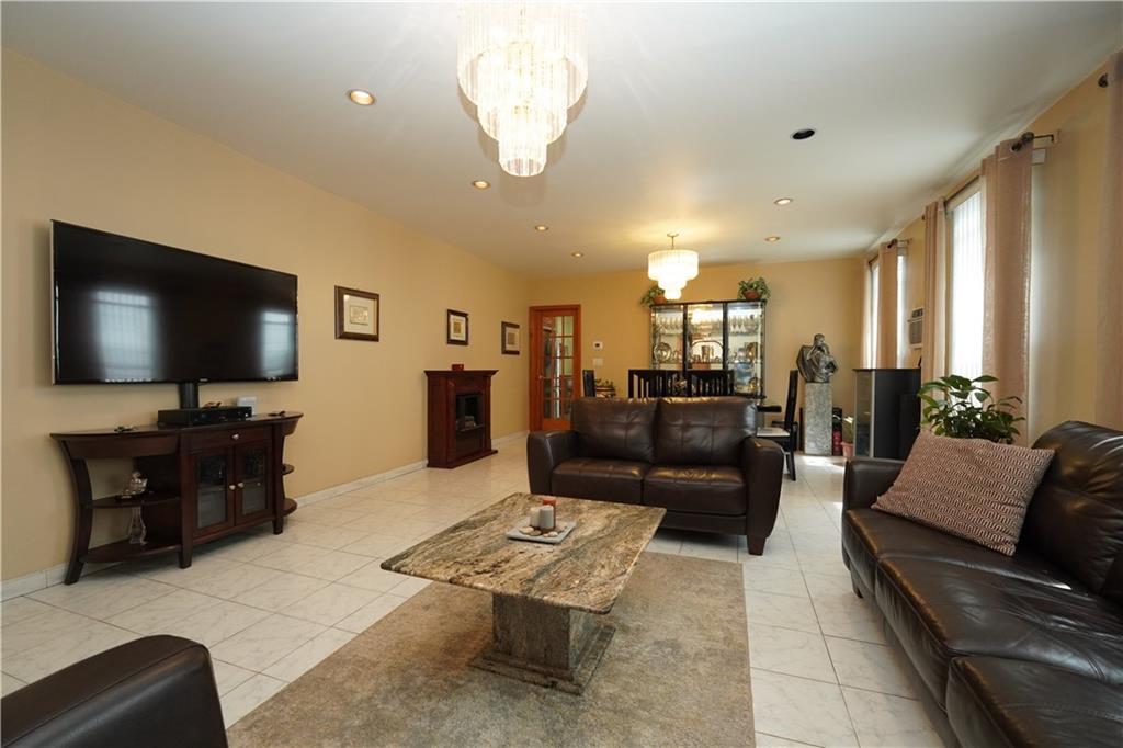 1463 84th Street Brooklyn, NY 11228 - Photo 9 of 30 a living room with furniture and a flat screen tv