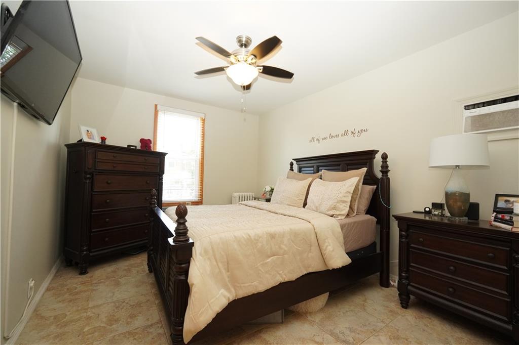 1463 84th Street Brooklyn, NY 11228 - Photo 10 of 30 a bedroom with a bed and a ceiling fan