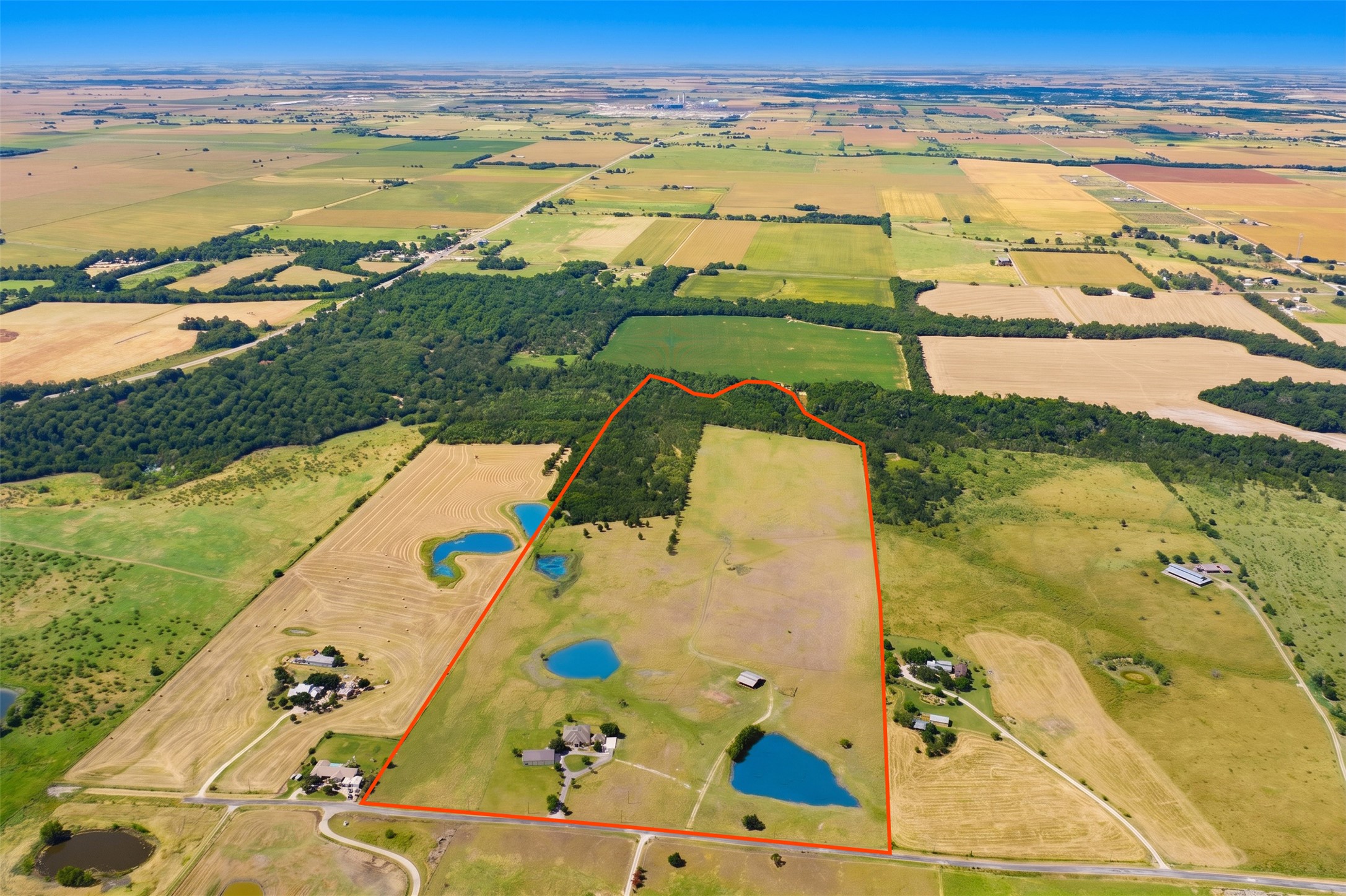 20145 Janak Road Coupland, TX 78615 - Photo 5 of 40 Vast acreage featuring multiple serene ponds and natural wooded areas offers privacy and potential.