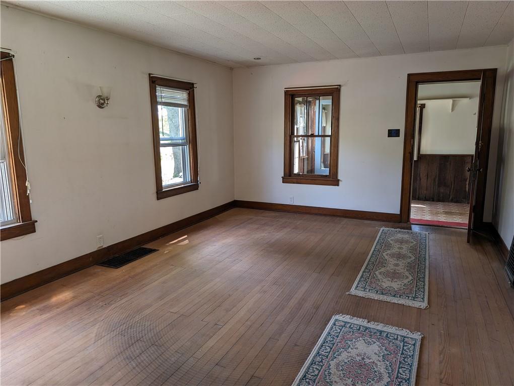 488 Highland Ridge Road Claysville, PA 15323 - Photo 13 of 29 an empty room with wooden floor and windows