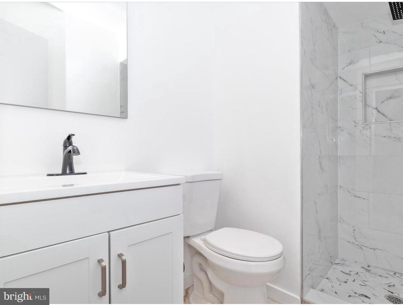 3930 Ferrara Drive Silver Spring, MD 20906 - Photo 11 of 15 a bathroom with a sink a toilet and shower