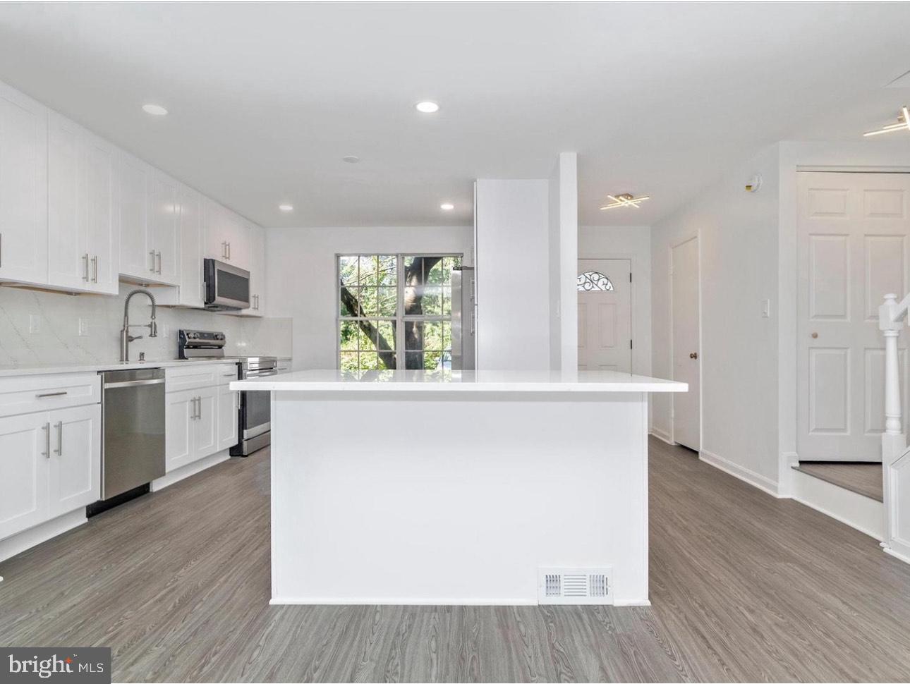 3930 Ferrara Drive Silver Spring, MD 20906 - Photo 3 of 15 a kitchen with a stove a sink and a refrigerator