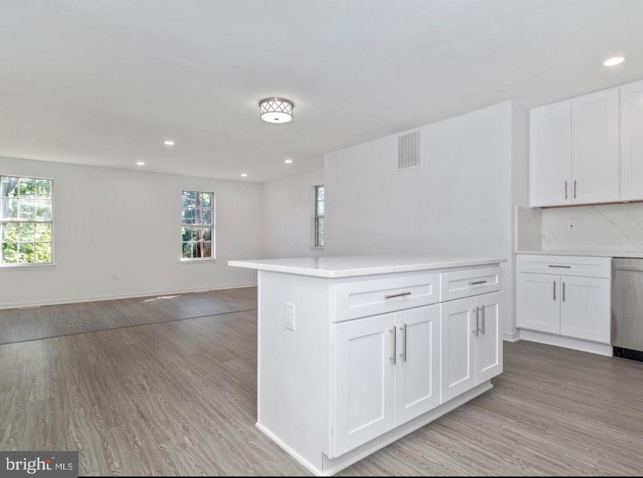 3930 Ferrara Drive Silver Spring, MD 20906 - Photo 5 of 15 a kitchen with white cabinets and sink