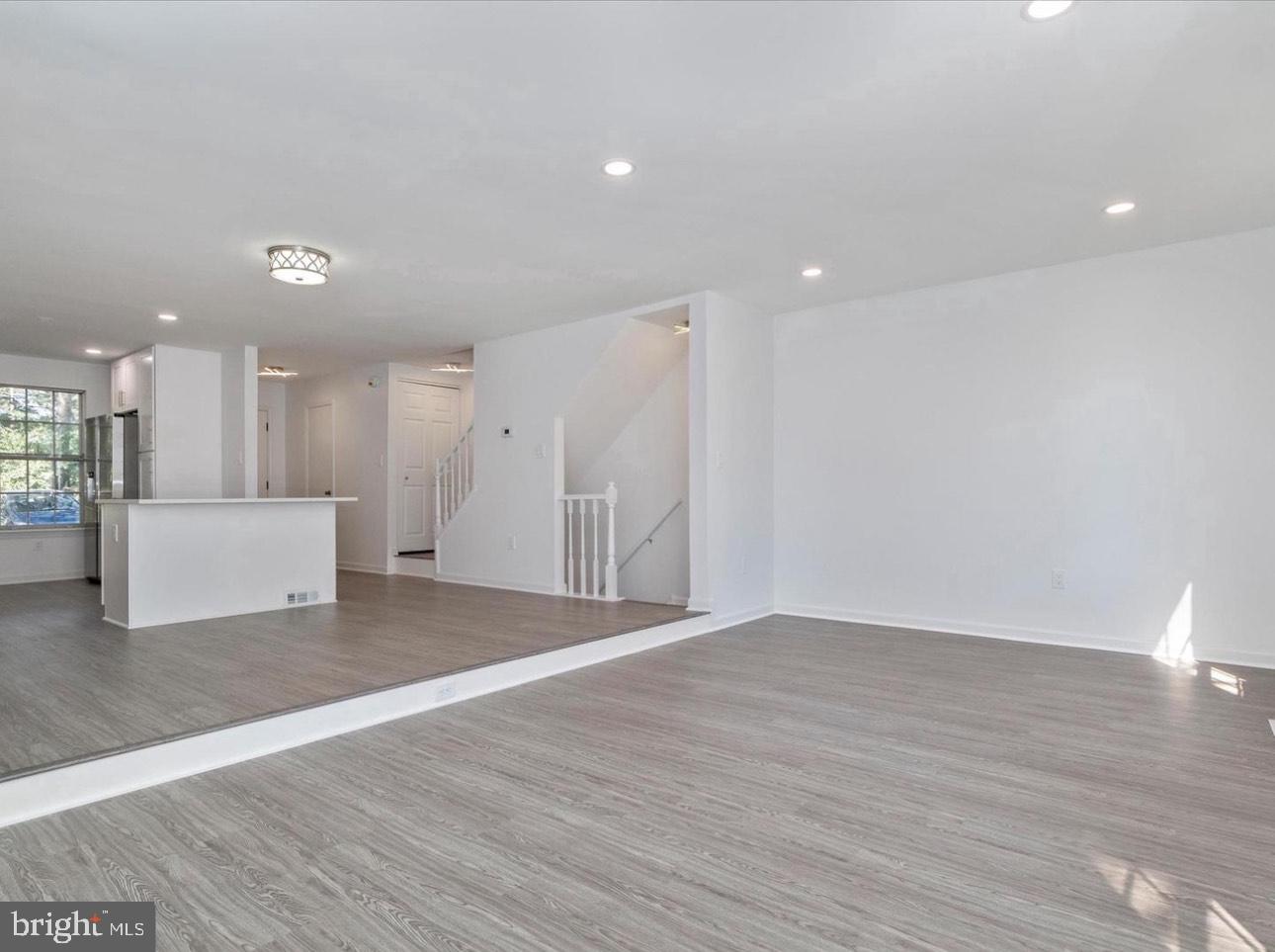 3930 Ferrara Drive Silver Spring, MD 20906 - Photo 6 of 15 a view of a kitchen with white cabinets and wooden floor