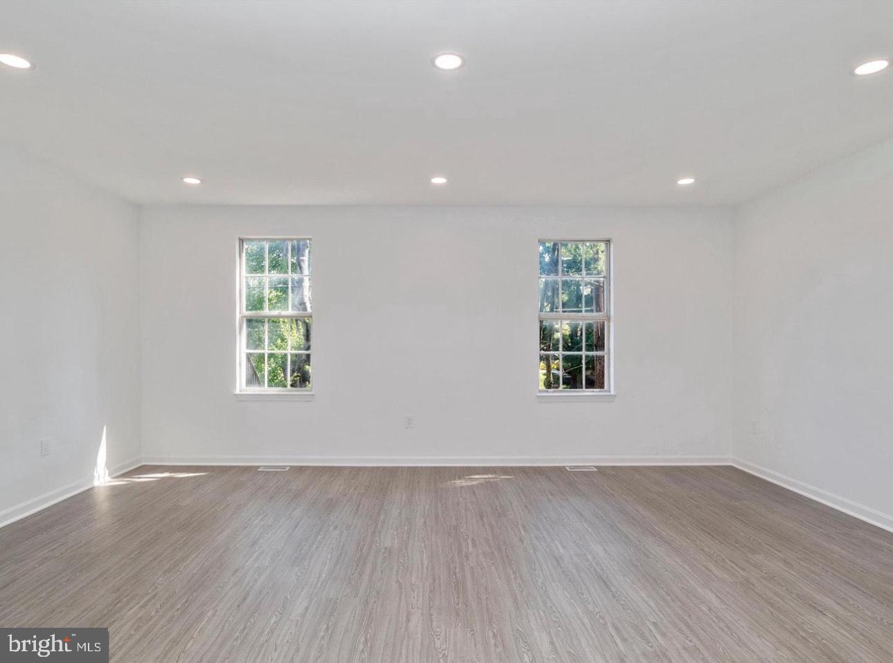 3930 Ferrara Drive Silver Spring, MD 20906 - Photo 7 of 15 an empty room with wooden floor and windows