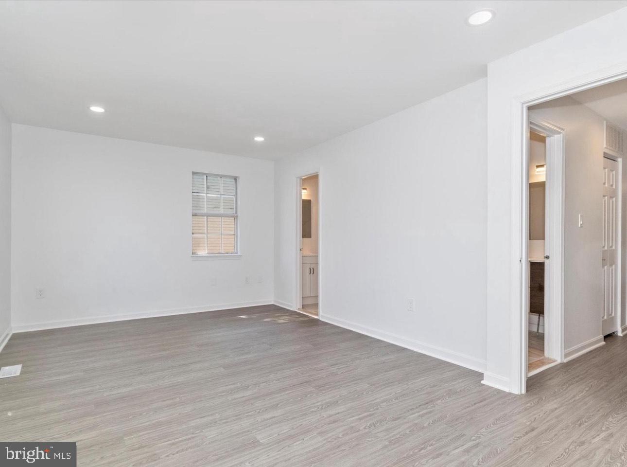 3930 Ferrara Drive Silver Spring, MD 20906 - Photo 8 of 15 an empty room with wooden floor & windows