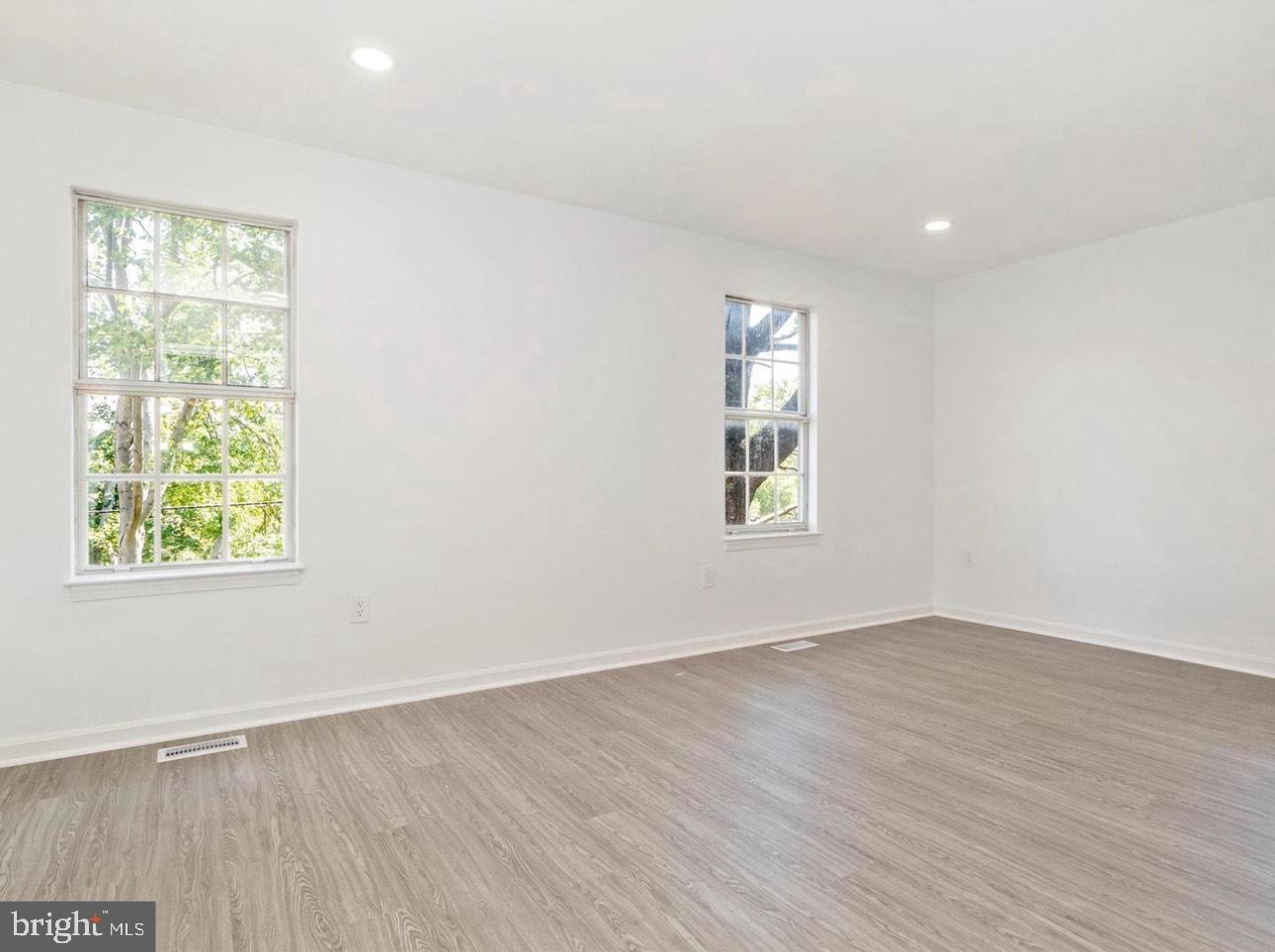 3930 Ferrara Drive Silver Spring, MD 20906 - Photo 9 of 15 an empty room with wooden floor and windows