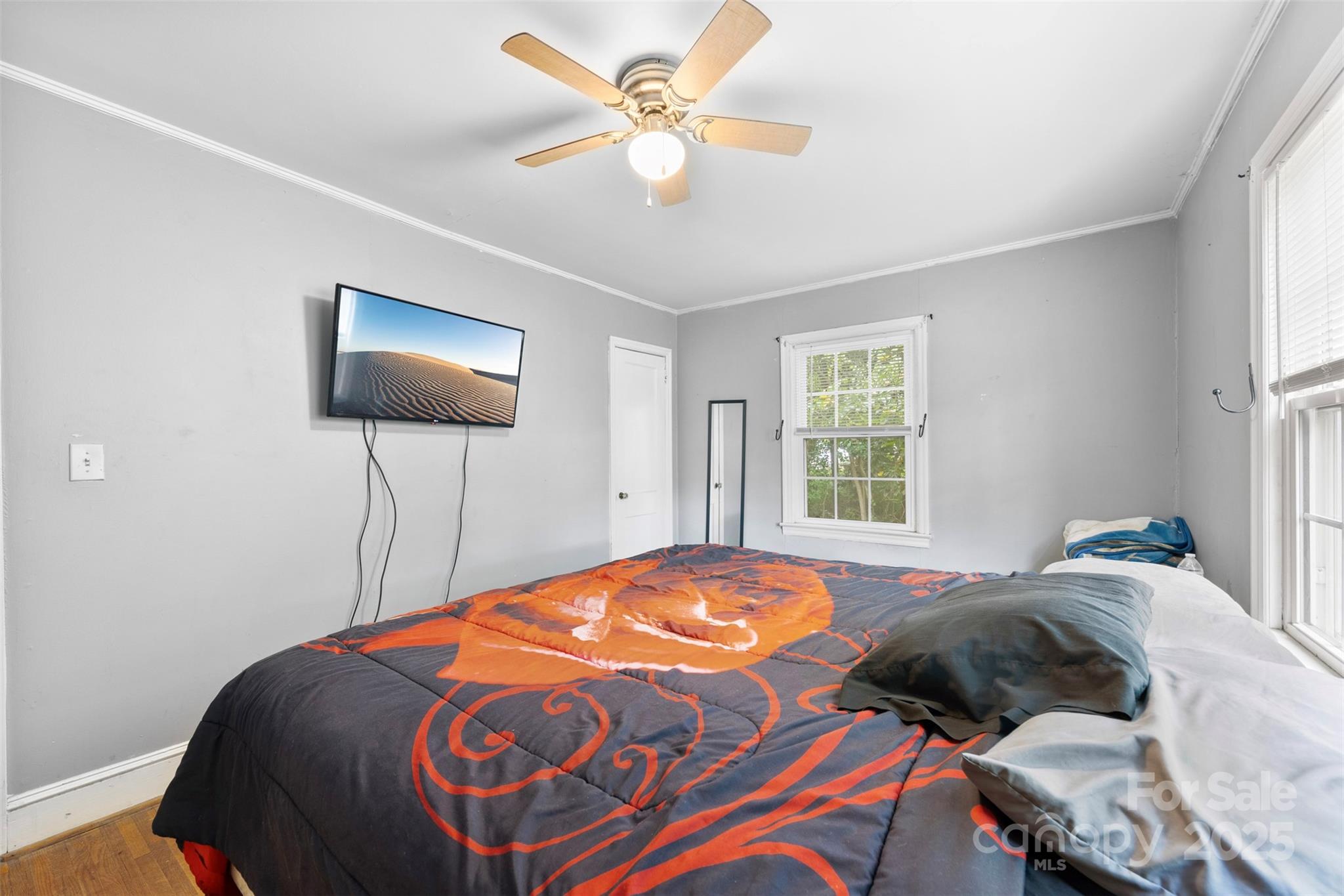 310 South Main Street Stanley, NC 28164 - Photo 14 of 22 a bedroom with a bed and a flat screen tv