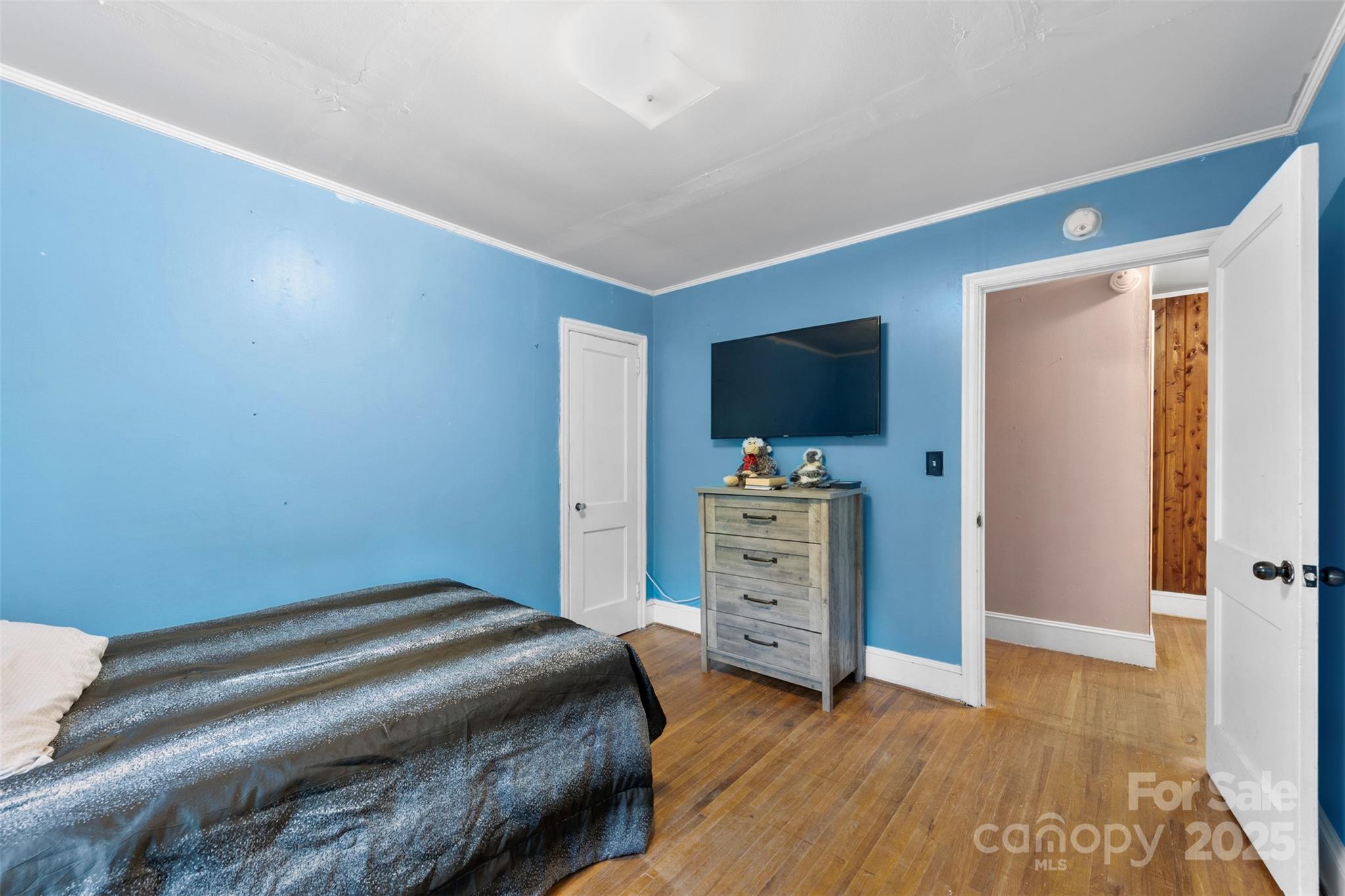 310 South Main Street Stanley, NC 28164 - Photo 17 of 22 a bedroom with a bed and a flat tv screen on dresser