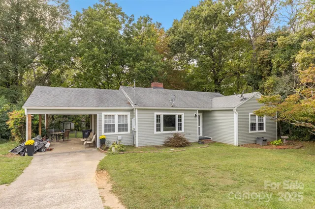 a view of a house with sitting area and garden