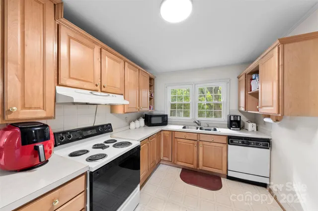 a kitchen with a sink stove top oven and cabinets