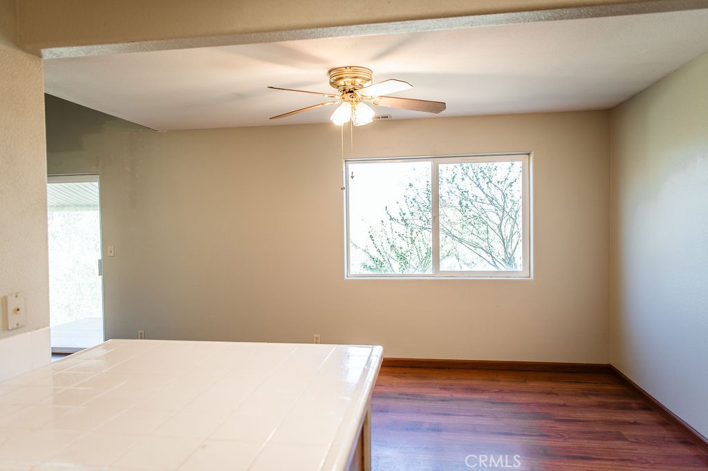 5085 Boyer Road Mariposa, CA 95338 - Photo 21 of 75 a view of an empty room with wooden floor and a window