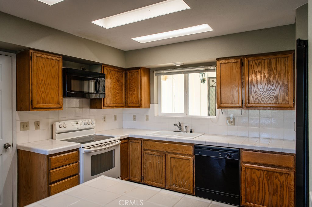 5085 Boyer Road Mariposa, CA 95338 - Photo 24 of 75 a kitchen with a sink stove top oven and cabinets