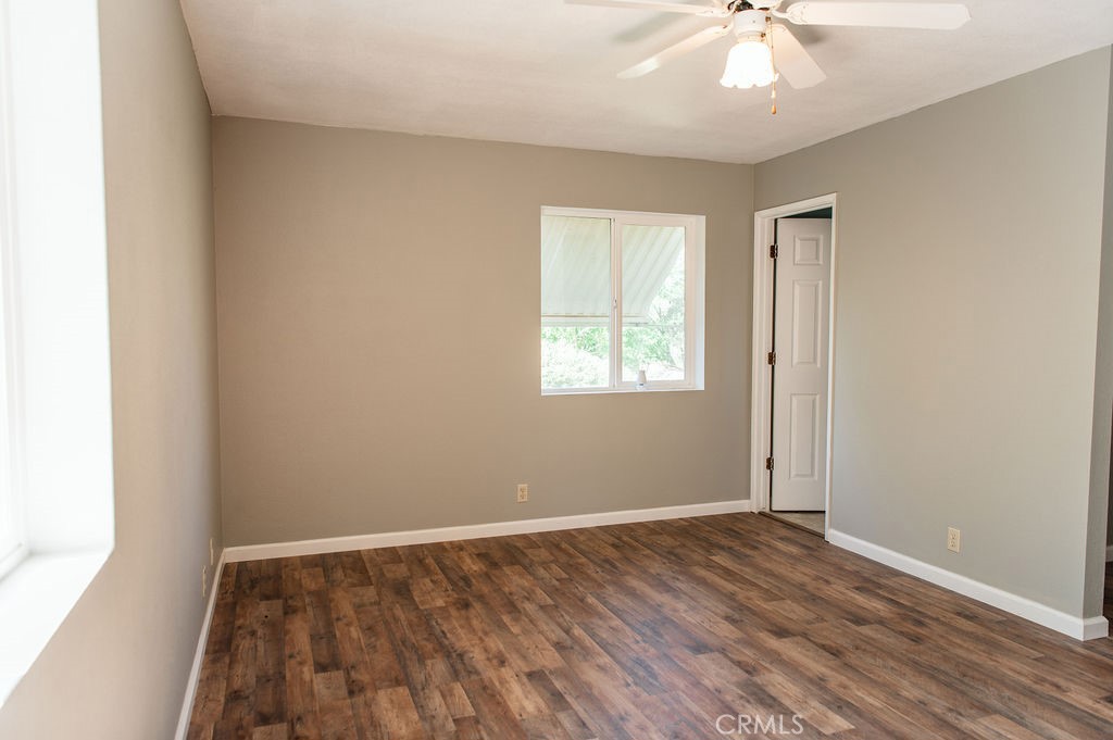 5085 Boyer Road Mariposa, CA 95338 - Photo 41 of 75 an empty room with wooden floor fan and windows