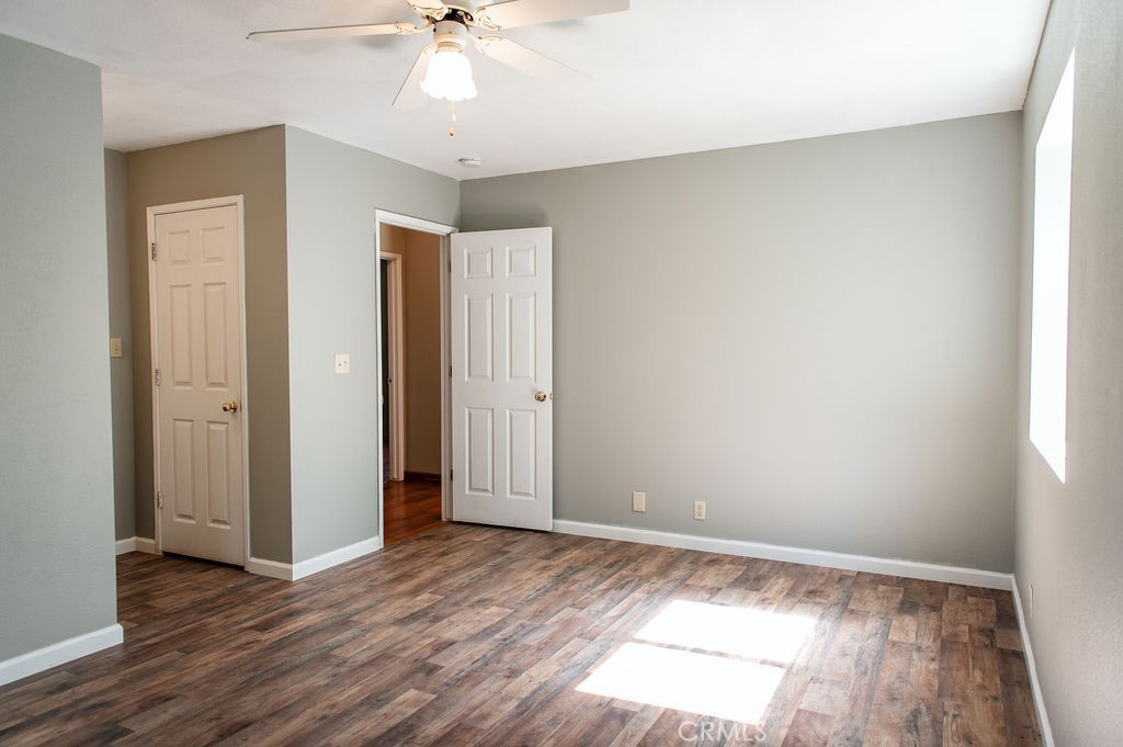 5085 Boyer Road Mariposa, CA 95338 - Photo 46 of 75 an empty room with wooden floor and ceiling fan