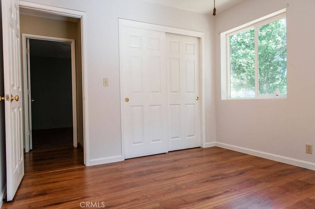 5085 Boyer Road Mariposa, CA 95338 - Photo 53 of 75 an empty room with wooden floor and windows