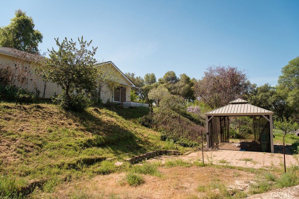 5085 Boyer Road Mariposa, CA 95338 - Photo 64 of 75 a backyard of a house with large trees and covered with snow