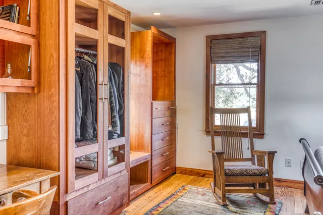 a view of a bedroom with furniture and a window
