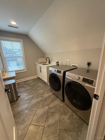 a balcony with wooden floor table and chairs