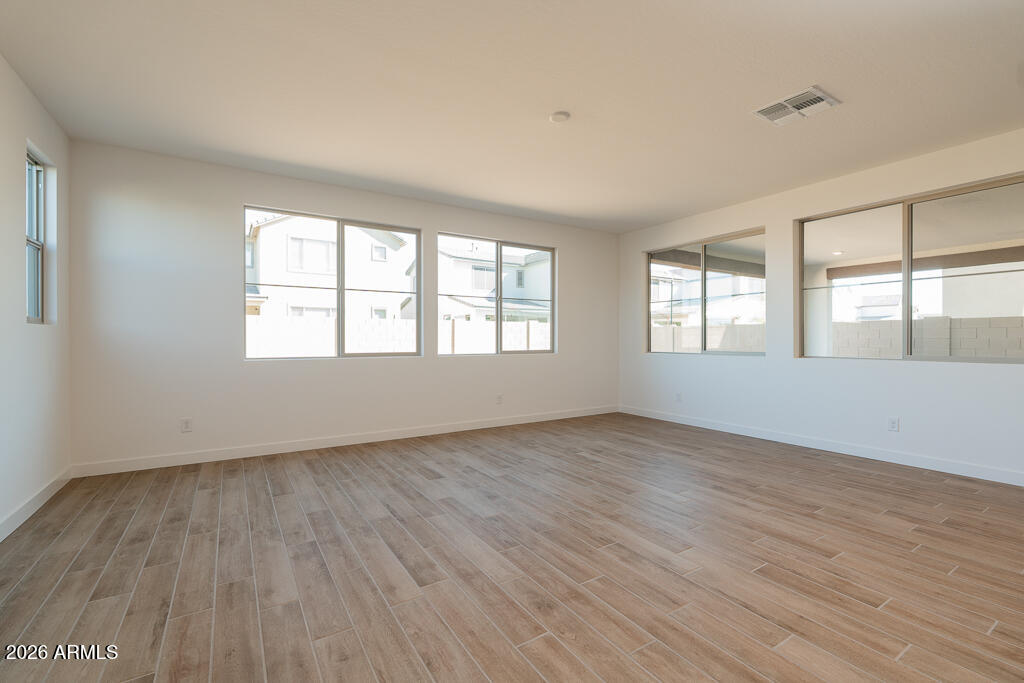 5857 South Granite Street Gilbert, AZ 85298 - Photo 5 of 20 an empty room with wooden floor and windows