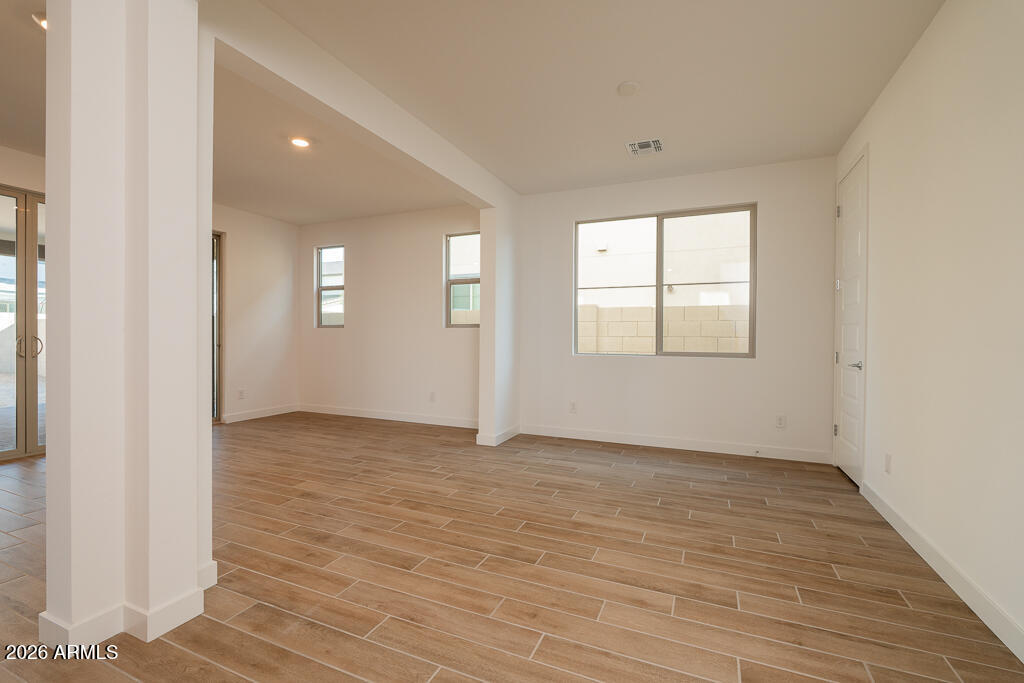 5857 South Granite Street Gilbert, AZ 85298 - Photo 6 of 20 an empty room with wooden floor and windows