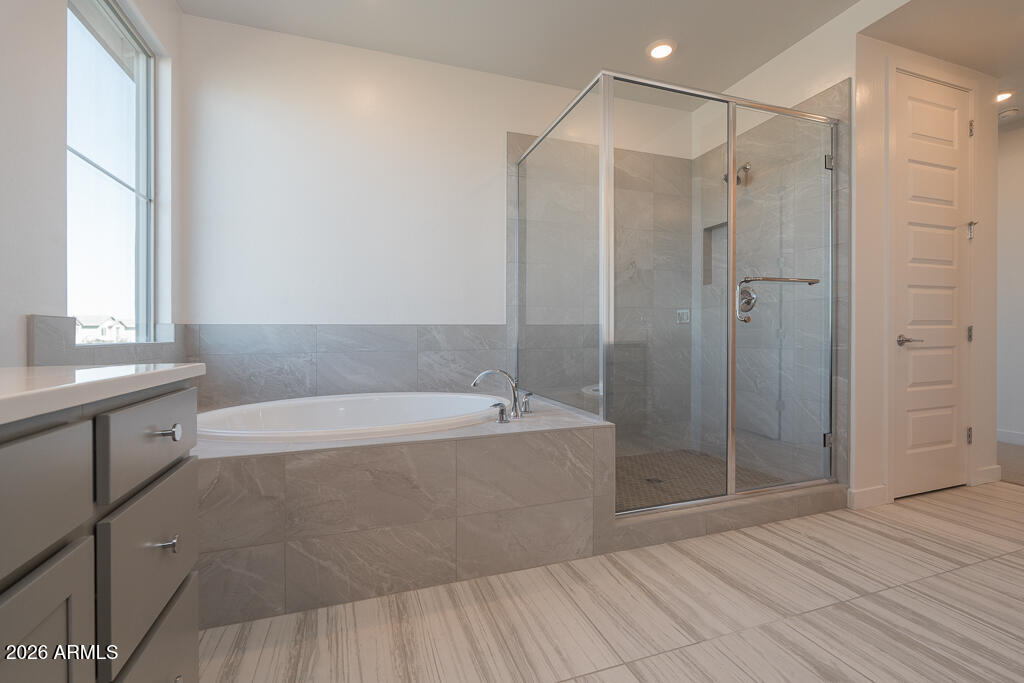 5857 South Granite Street Gilbert, AZ 85298 - Photo 9 of 20 a bathroom with a bathtub and a shower